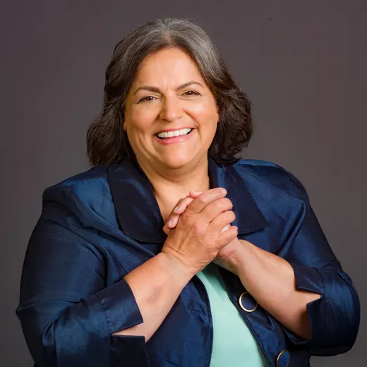 Esmeralda Reynolds smiling with her hands clasped